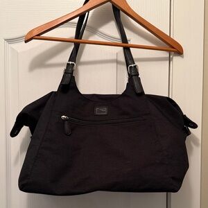 Roots Black Tote Bag with adjustable straps and a front zipper pocket